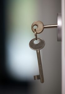 Close-up shot of keys in the keyhole. Locking or unlocking the door