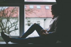 young girl sitting at window thinking for Freshers' article