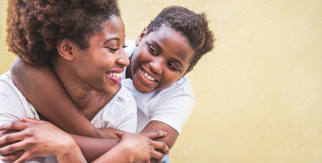 Young boy hugging mum