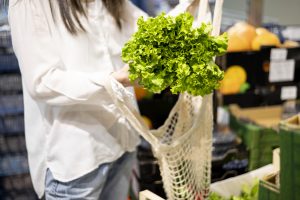 Lettuce being placed into string bag for Reduce Single Use Plastic article