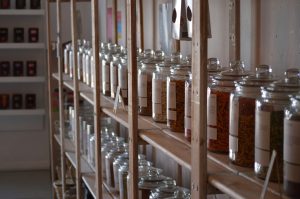 Row of jars on shelf in zero waste shop for Reduce Single Use Plastic article