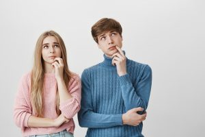 Boy and girl standing near each other having pensive expressions for Child Trust Fund article