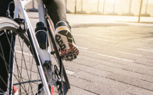 close up of foot wearing a trainer pushing down on a bike pedal for remote learning tips article