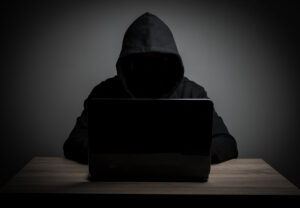 Shadowy figure on a computer for fake news blog