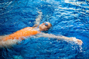 Girl keeping safe in the water by floating in a star shape