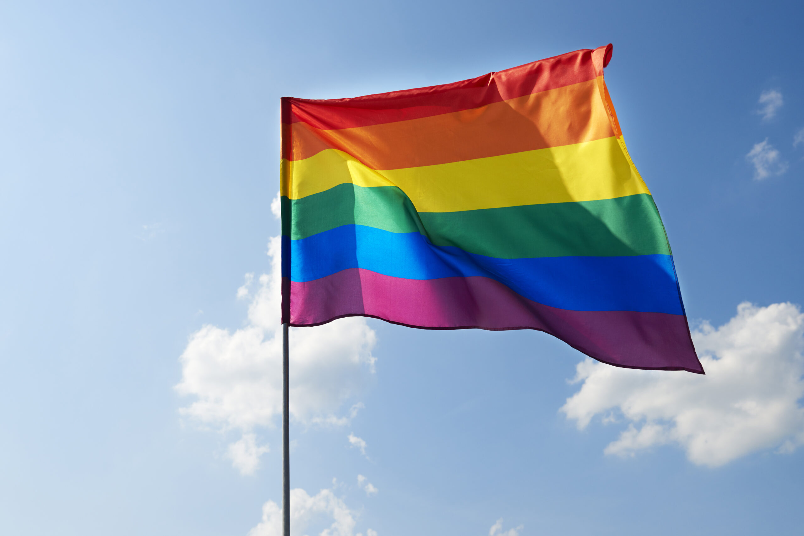 A symbol of pride: raising the rainbow flag