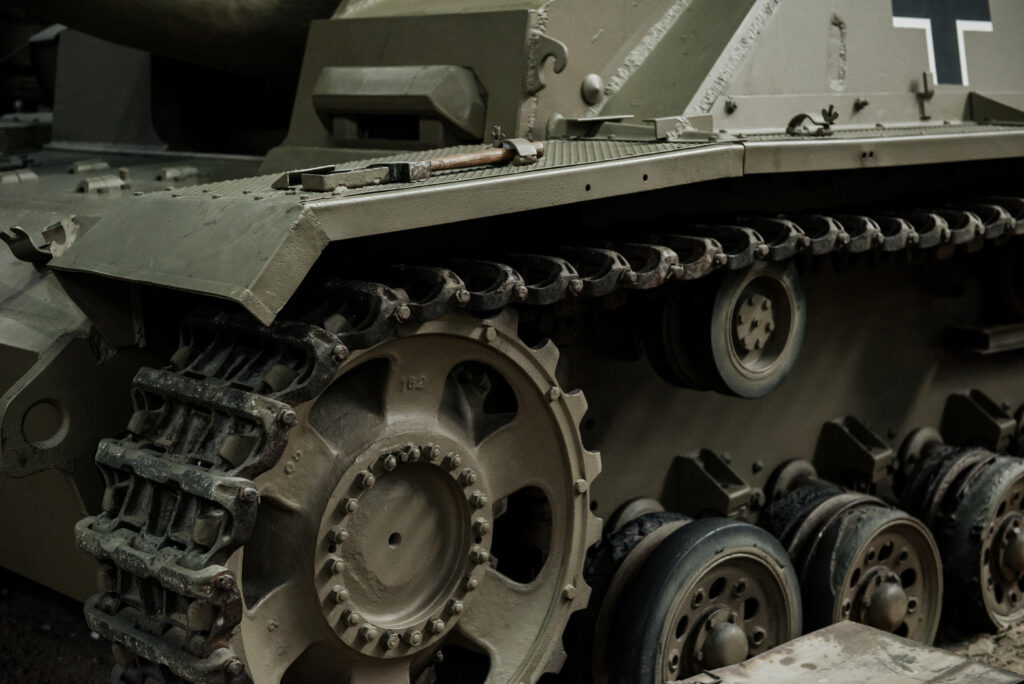 Technik Museum. Caterpillar vehicle. Close up photo of the old tank standing indoors at exhibition for for What's Happening Between Russia and Ukraine? blog