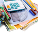 Various school supplies including notebooks, calculator and pencil case isolated against a white background -for What To Expect On The Day Of Exams blog