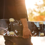 Close up of an african man skateboarder standing with a skateboard for Things to Do After Exams blog