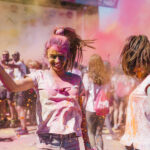 Young girl covered in pink paint powder for University guide blog