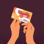 Hands holding loyalty club plastic card. Discount offer, gift for shopping.