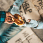 Two hands - one begging the other handing out food