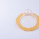 Latex condom on white background