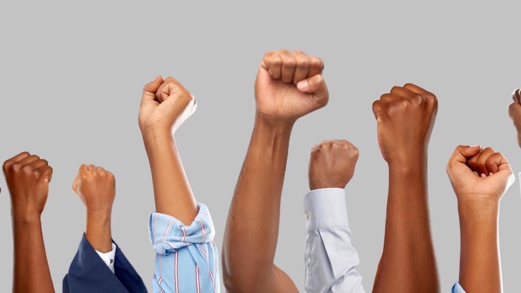 People of different ages raising their fists in the air