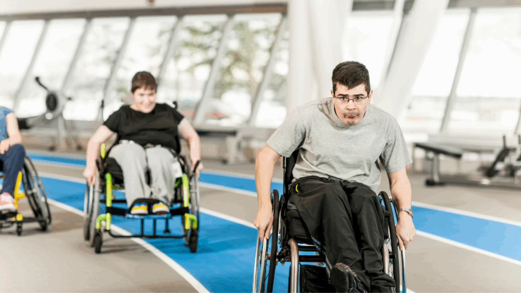 Two disabled teens wheeling around an indoor race track