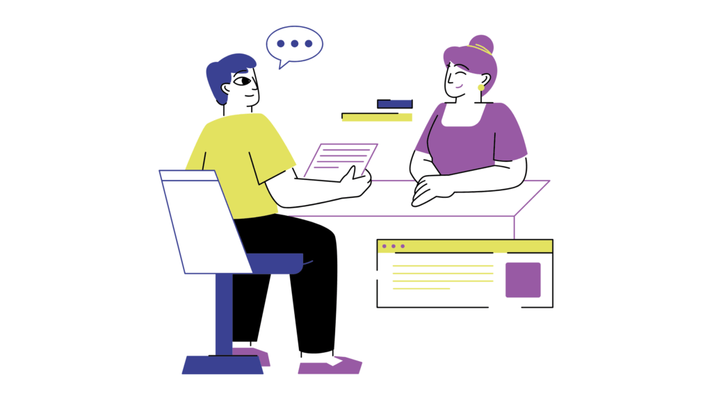 Two people talking at a desk