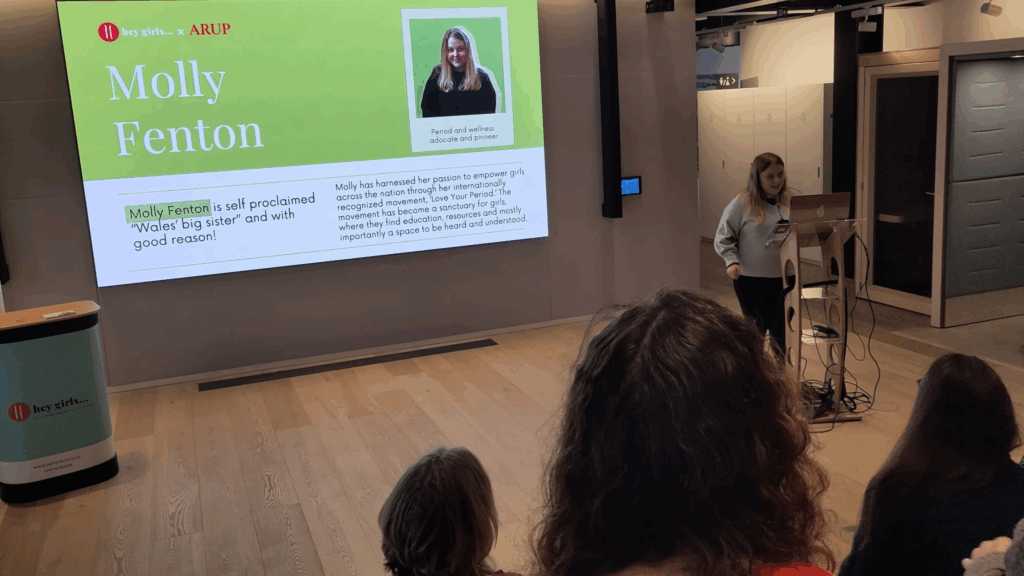 Molly Fenton giving a talk in a conference room