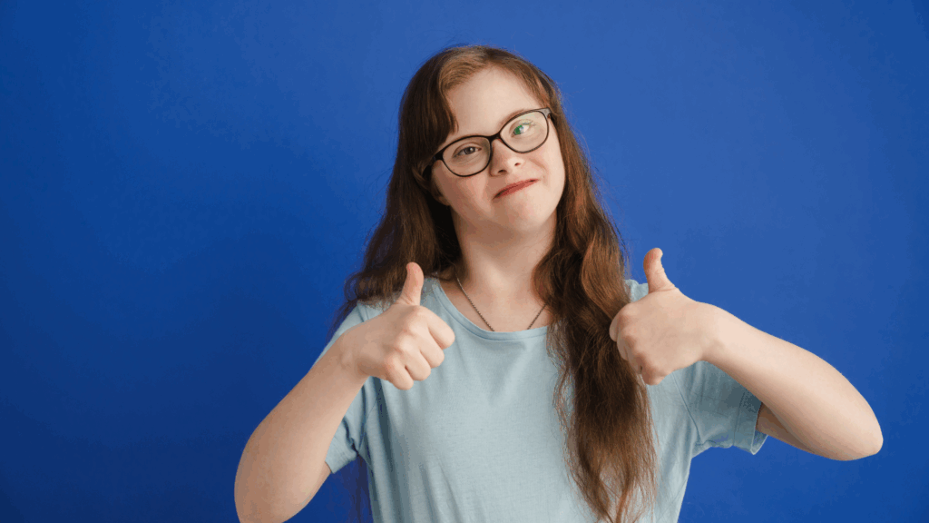 Young adult with down syndrome doing thumbs up