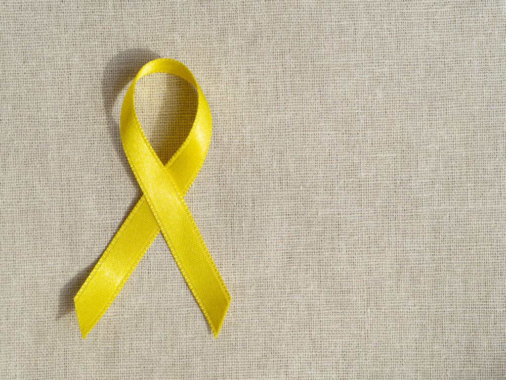 A picture of a yellow ribbon - the symbol for suicide prevention awarness