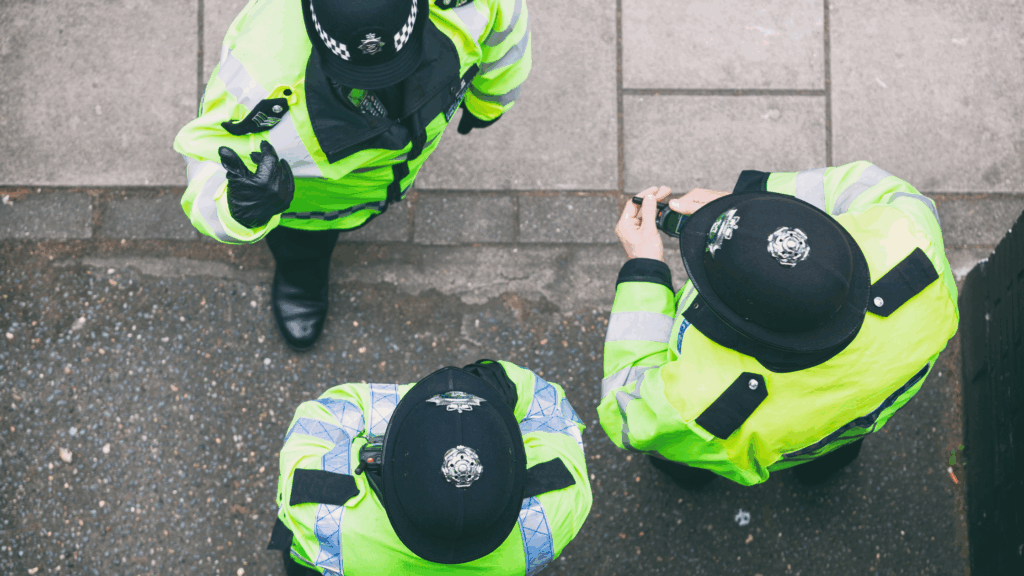 3 police officers stood together in a circle