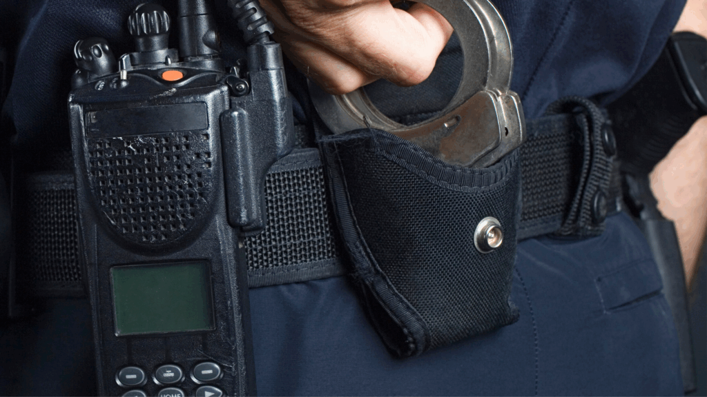 Phone and handcuffs on police officers hip