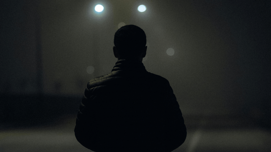 Person walking the street at night by themselves